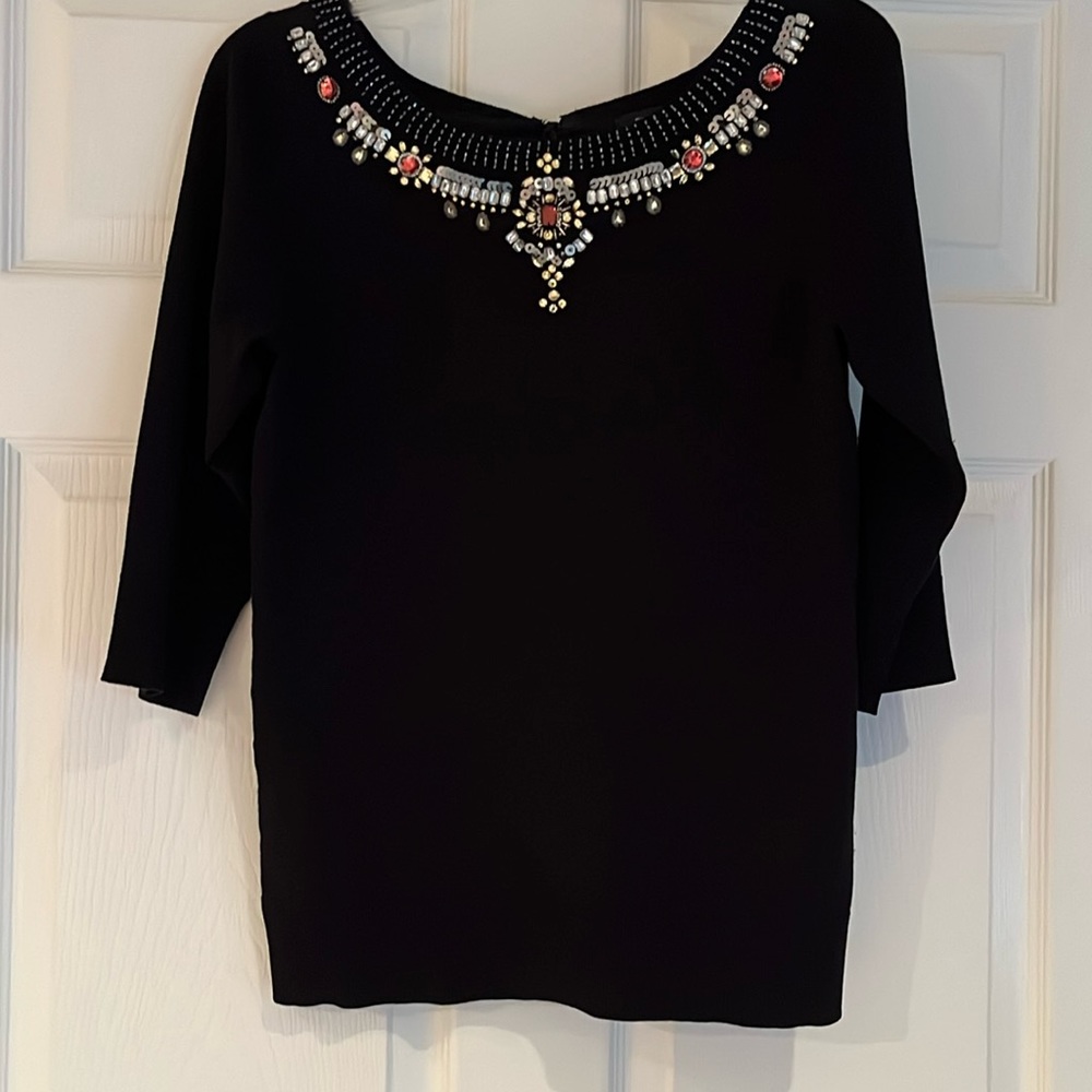 Black sweater with jeweled neckline, satin bow in back and 3/4 length sleeves.